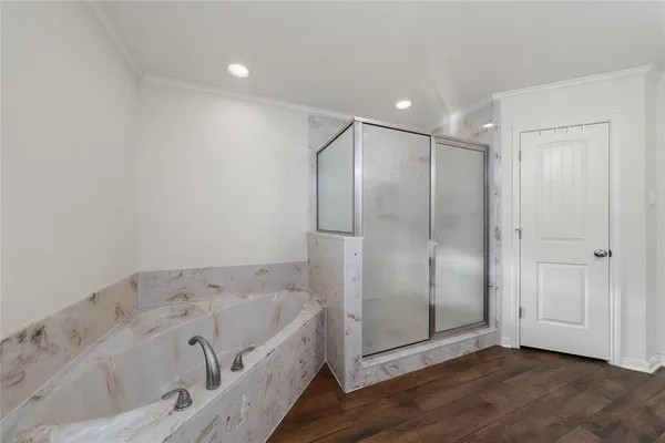 a bathroom with a bathtub and a shower