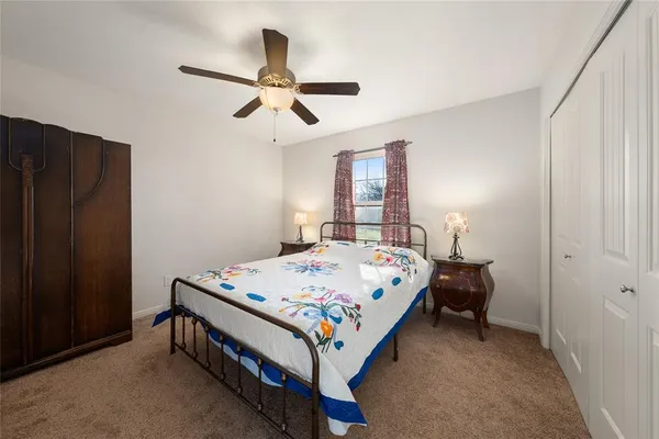 a bed sitting in a bedroom next to a window
