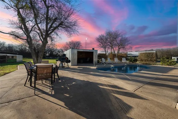 a patio with a yard table and chairs