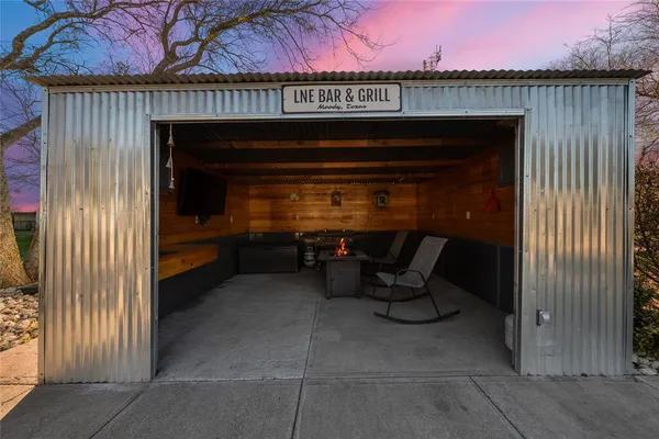 a view of patio with a table and chairs