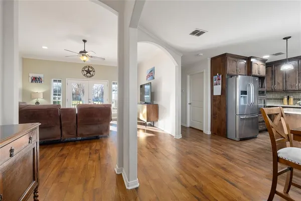 a living room with furniture and a wooden floor