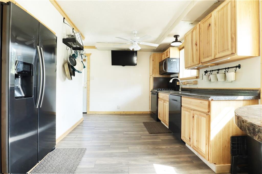 46 Rural Avenue Washington, PA 15301 - Photo 3 of 22 a kitchen with stainless steel appliances granite countertop a refrigerator a stove and a sink with wooden floor