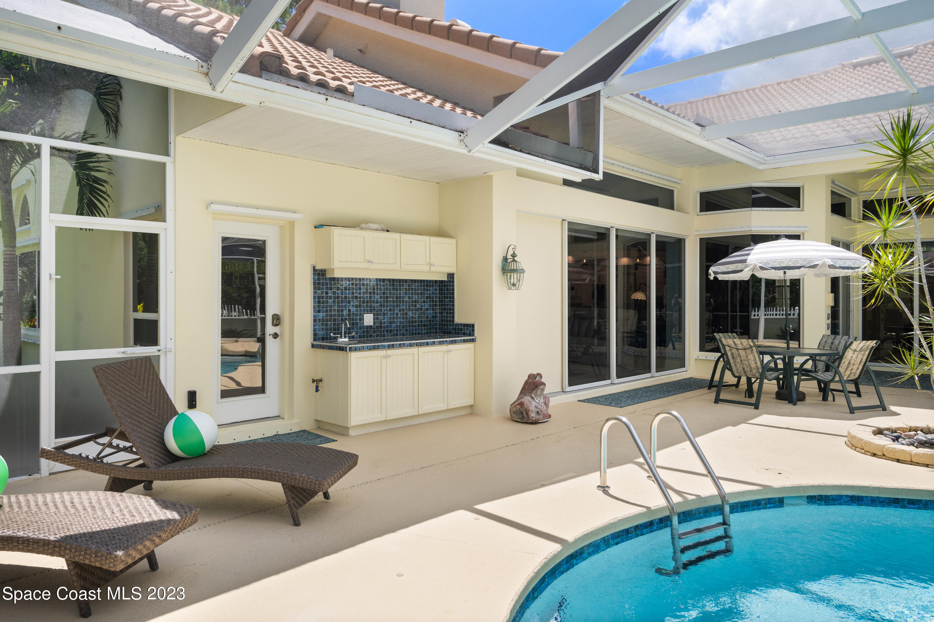 Undisclosed Address Vero Beach, FL 32967 - Photo 16 of 36 a building outdoor space with patio furniture and potted plant