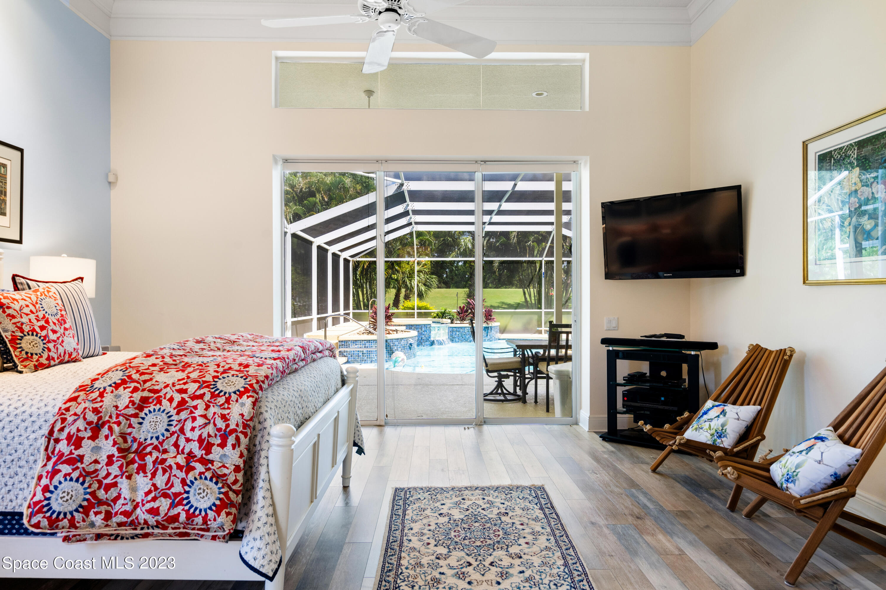 Undisclosed Address Vero Beach, FL 32967 - Photo 18 of 36 a bedroom with furniture and a flat screen tv