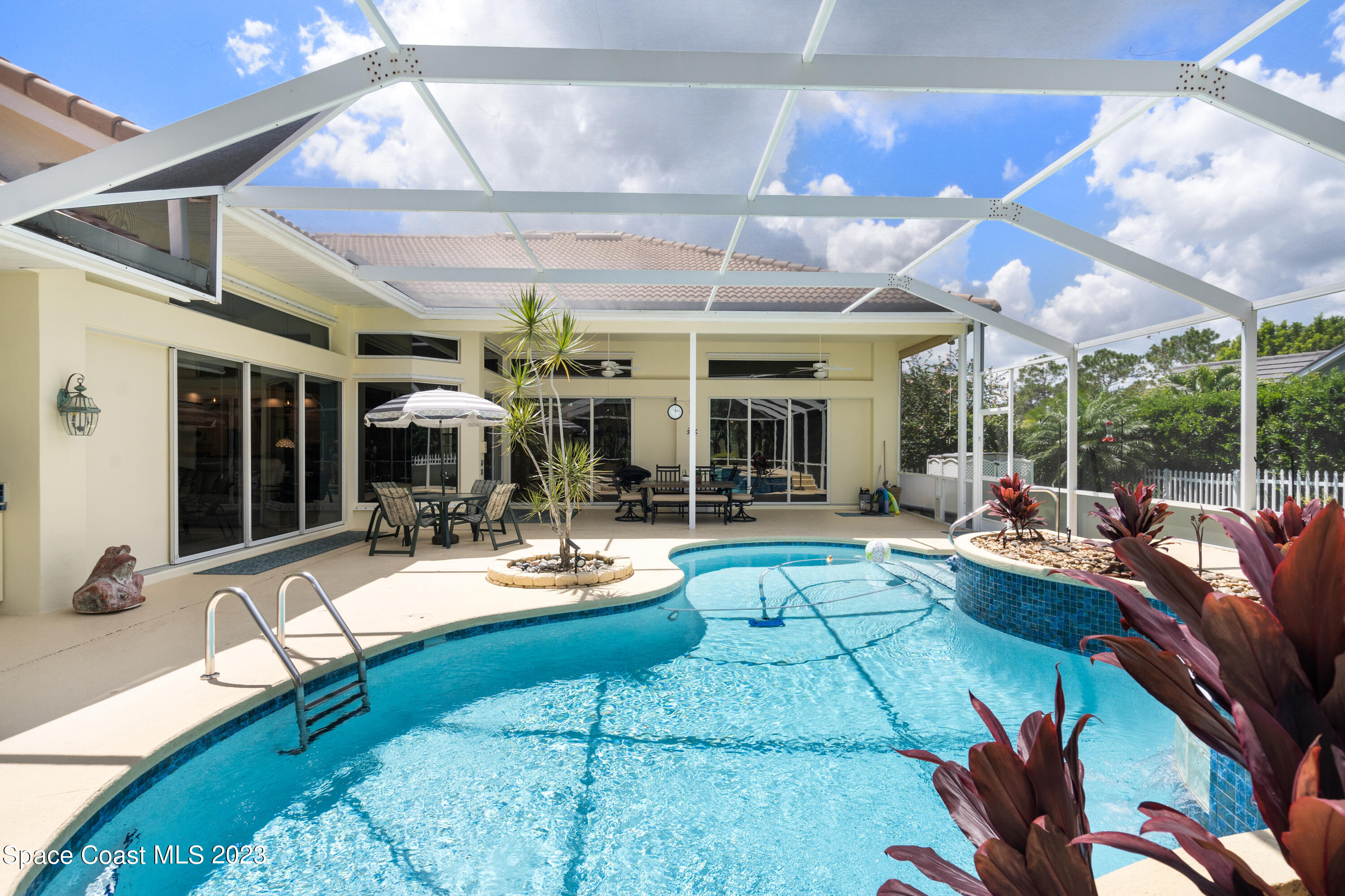 Undisclosed Address Vero Beach, FL 32967 - Photo 2 of 36 a view of a patio with dining table and chairs with wooden floor and fence