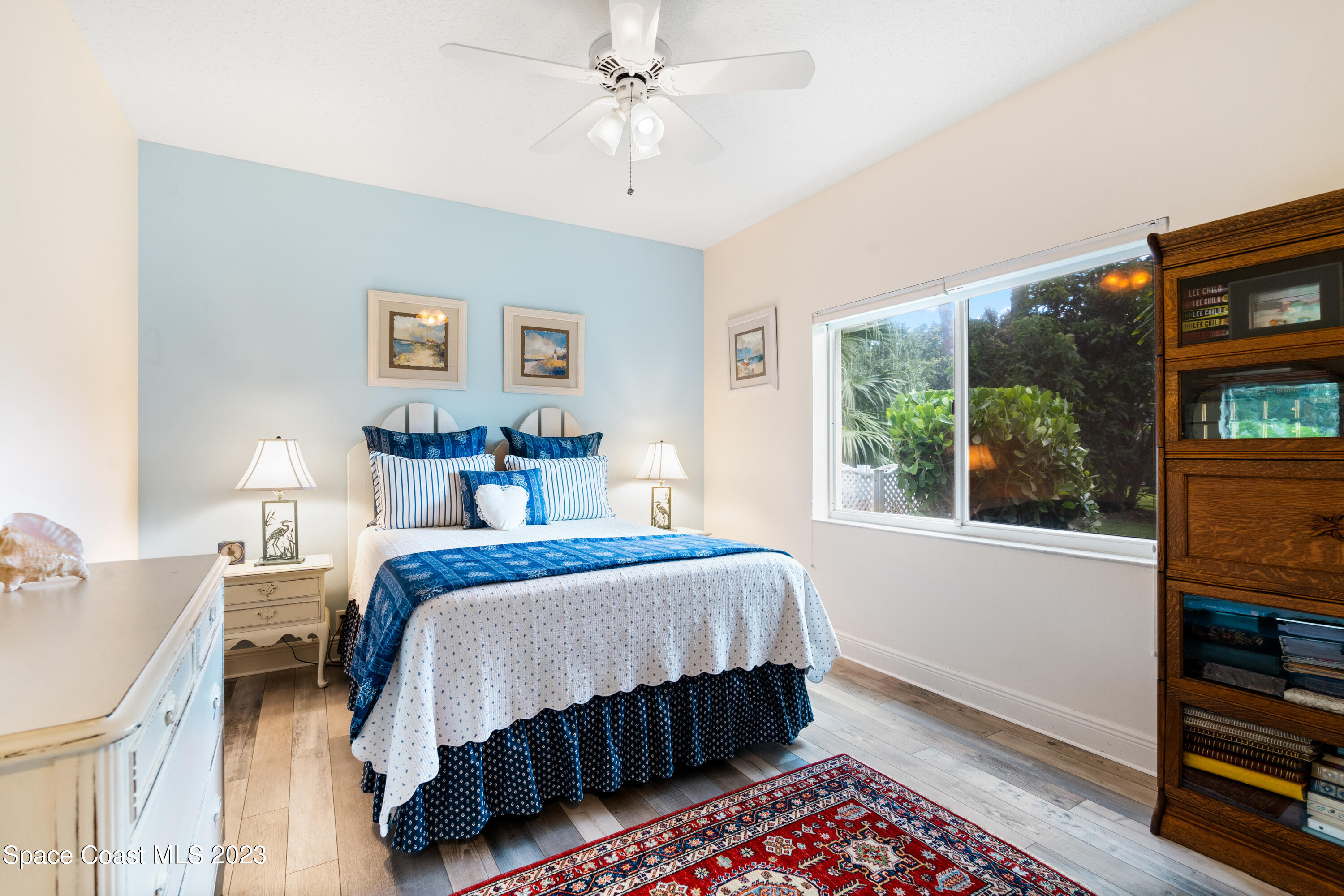 Undisclosed Address Vero Beach, FL 32967 - Photo 25 of 36 a bedroom with a bed a dresser and a large window