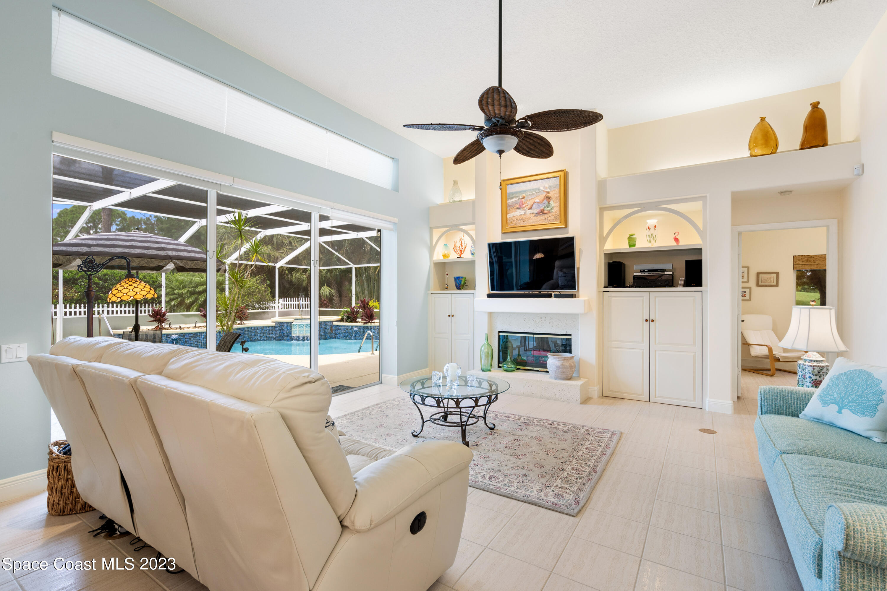 Undisclosed Address Vero Beach, FL 32967 - Photo 3 of 36 a living room with furniture a fireplace and a chandelier