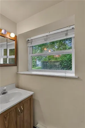 a bathroom with a sink and a window