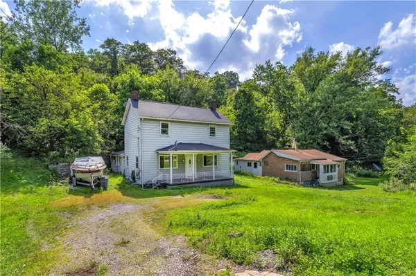 a house view with a sitting space and garden