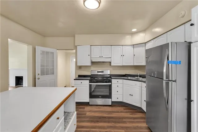 a kitchen with stainless steel appliances a refrigerator stove and sink