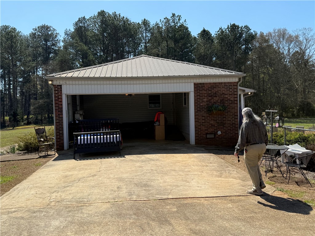 121 Nautical Way Anderson, SC 29625 - Photo 5 of 37 A detached garage with a sturdy metal roof and brick facade provides ample parking.