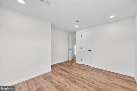 a view of hallway with wooden floor