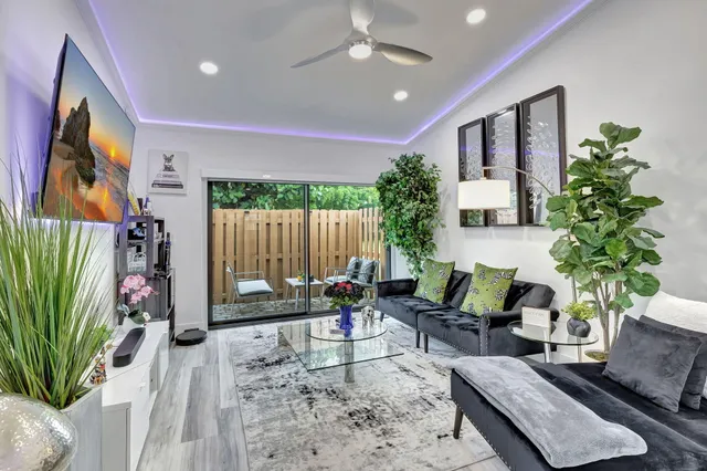 a living room with furniture and flowers