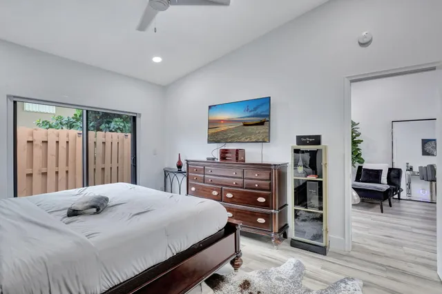 a bedroom with a bed and a painting on the wall