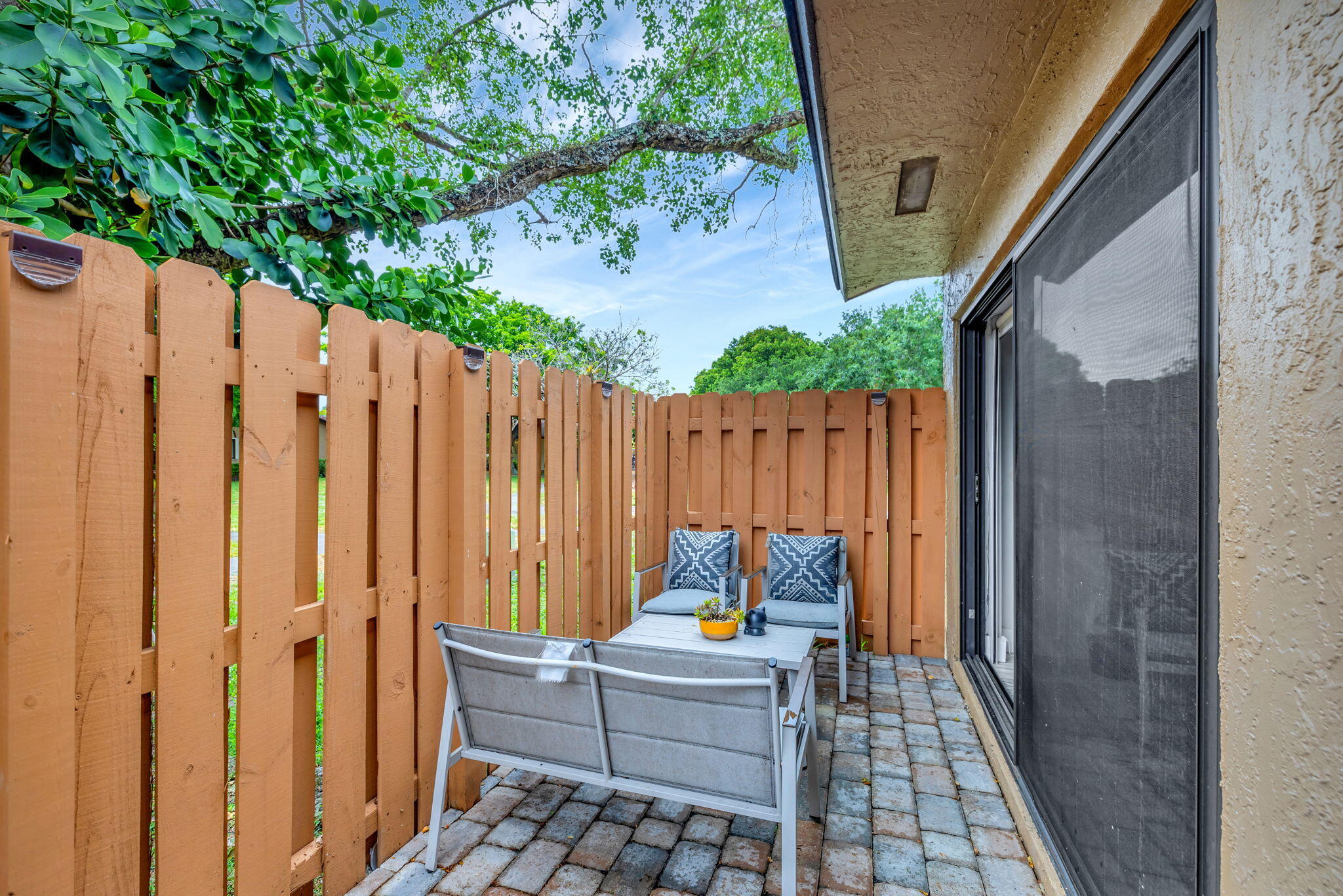 2320 Northwest 37th Avenue, Unit D29 Coconut Creek, FL 33066 - Photo 23 of 27 a white bench sitting in front of a door