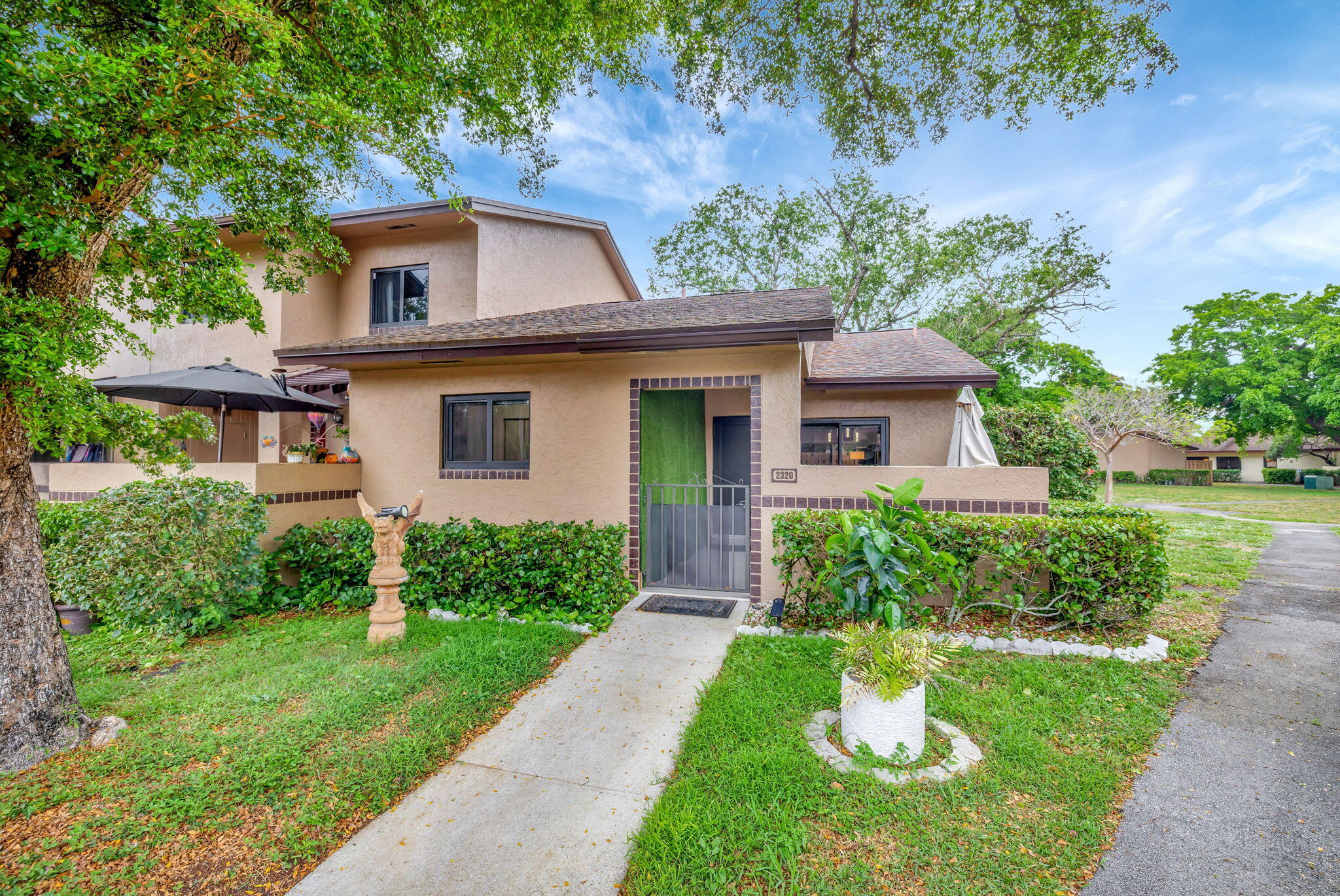 2320 Northwest 37th Avenue, Unit D29 Coconut Creek, FL 33066 - Photo 4 of 27 a front view of a house with a yard