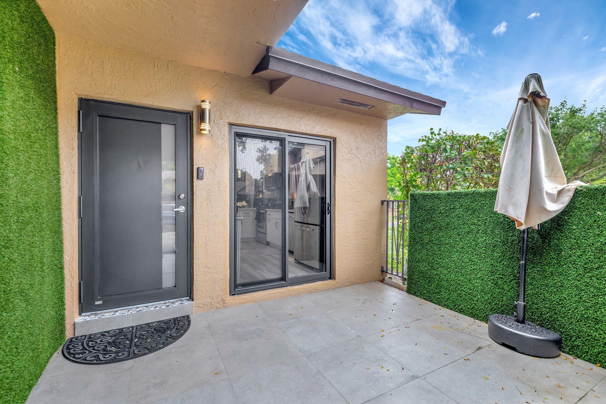 2320 Northwest 37th Avenue, Unit D29 Coconut Creek, FL 33066 - Photo 5 of 27 a view of a house with a yard and plants