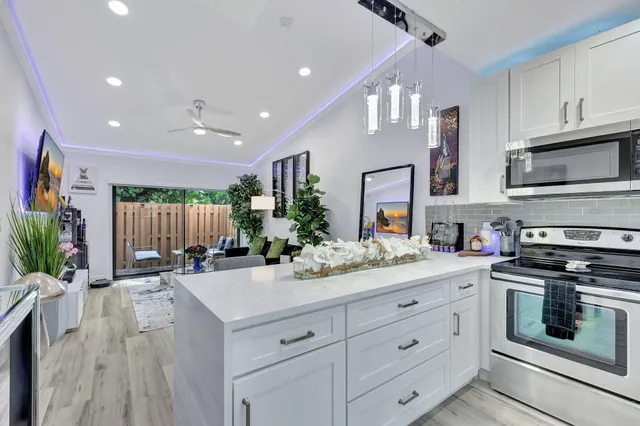a kitchen with a sink stove and microwave