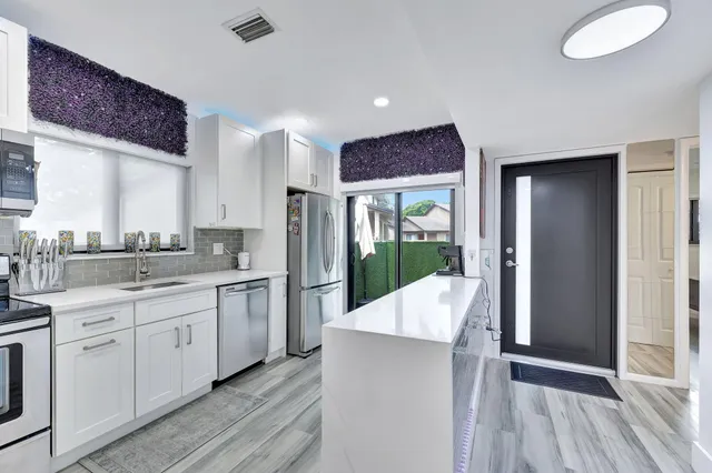 a kitchen with a sink stove and cabinets
