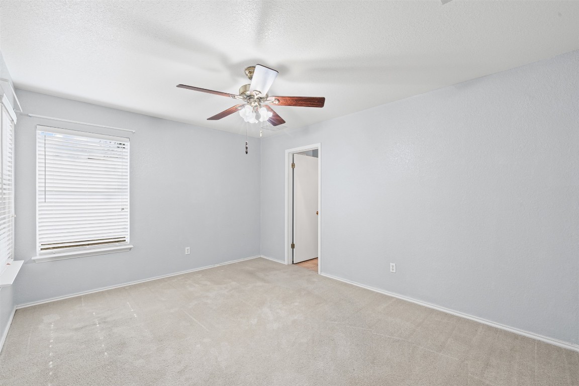 4707 Ridge Way Drive Temple, TX 76502 - Photo 13 of 29 an empty room with a window and a ceiling fan