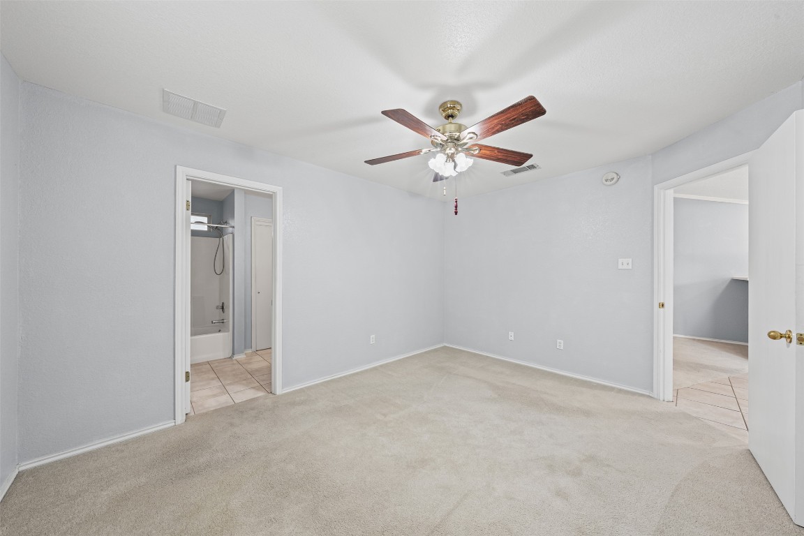 4707 Ridge Way Drive Temple, TX 76502 - Photo 14 of 29 an empty room with a hallway and a chandelier fan