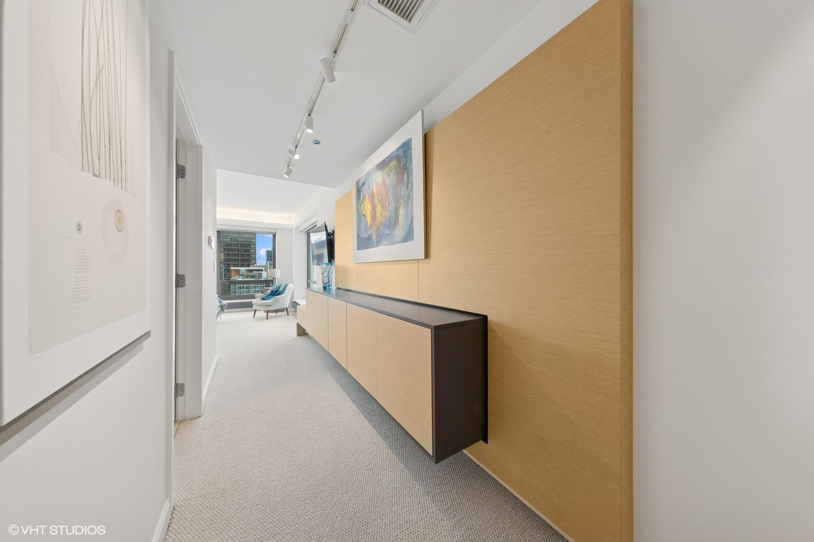 130 North Garland Court, Unit 4101 Chicago, IL 60602 - Photo 19 of 49 a view of a hallway with wooden floor and a living room