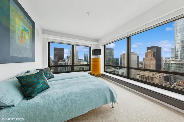 a bedroom with a large bed and a large window