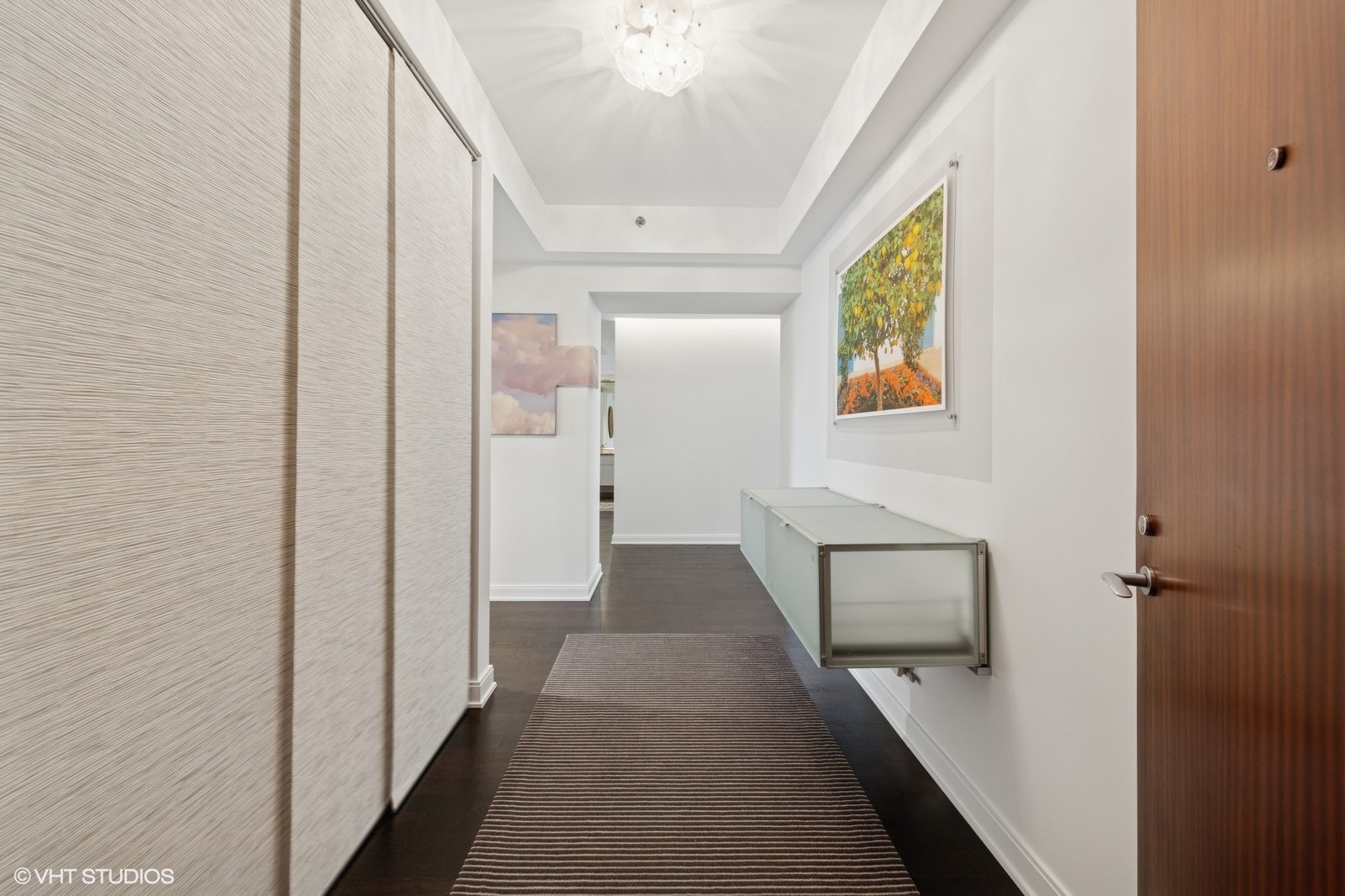 130 North Garland Court, Unit 4101 Chicago, IL 60602 - Photo 30 of 49 a view of a hallway with wooden floor and staircase
