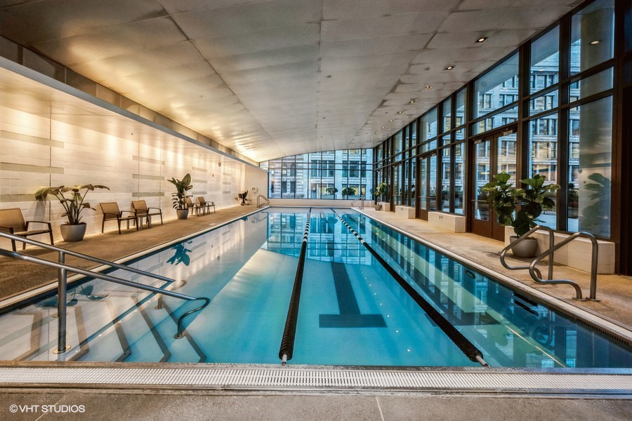 130 North Garland Court, Unit 4101 Chicago, IL 60602 - Photo 32 of 49 a large white kitchen with lots of counter top and glass windows