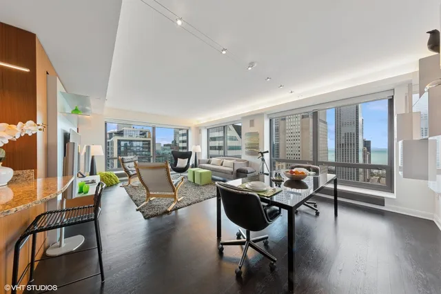 a living room with furniture and floor to ceiling windows