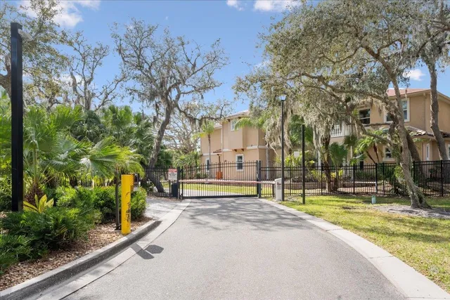 an aerial view of a house with a yard and lake view