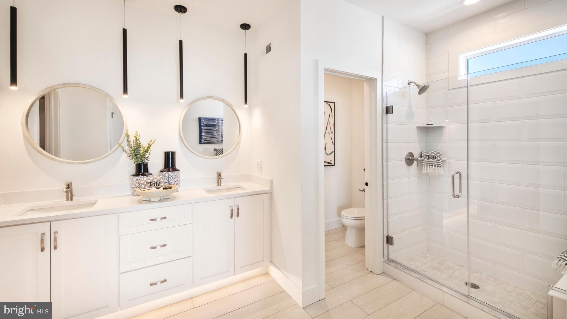 6103 Vivaldi Road Princeton, NJ 08540 - Photo 3 of 8 a bathroom with a double vanity sink mirror and shower