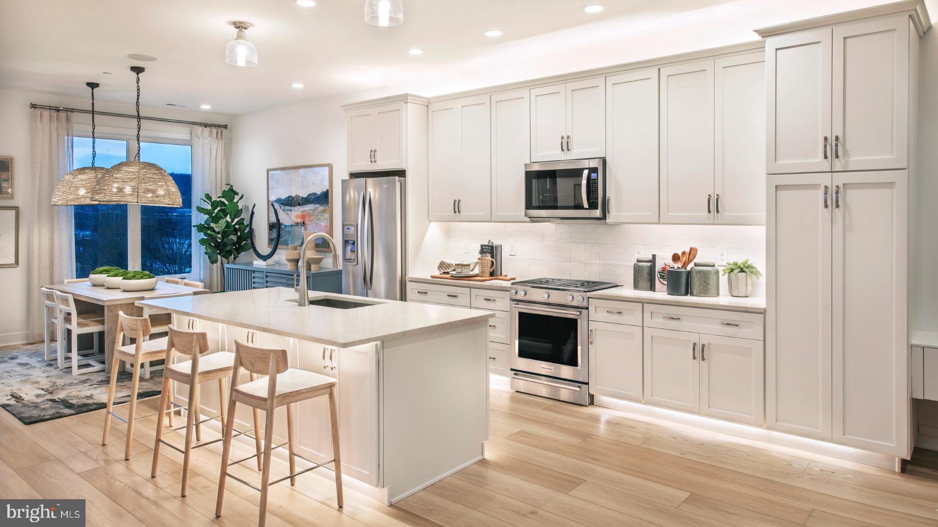 6103 Vivaldi Road Princeton, NJ 08540 - Photo 4 of 8 a kitchen that has a lot of white cabinets and stainless steel appliances