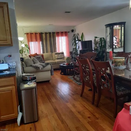 a living room with furniture window and wooden floor