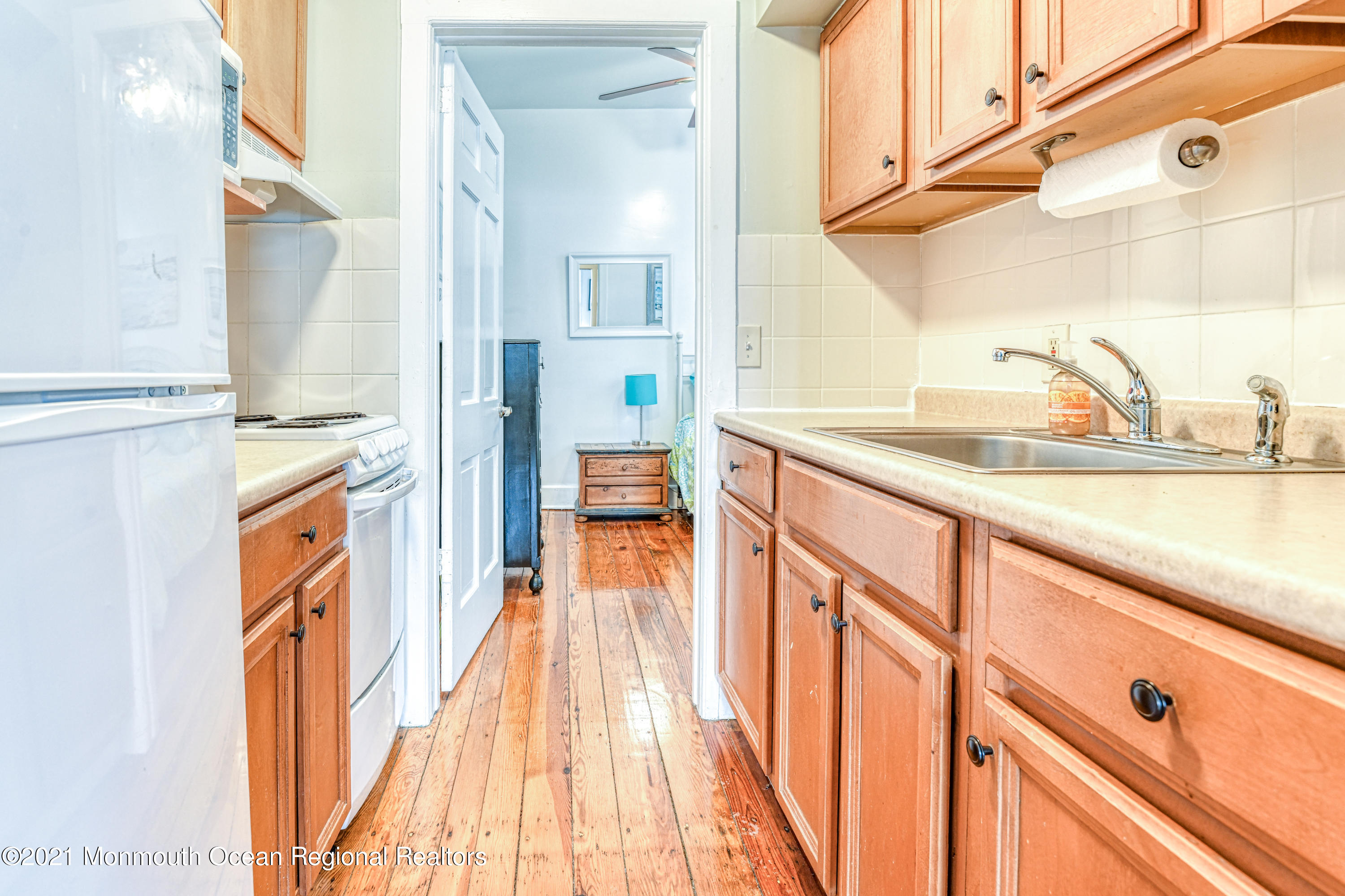 35 Ocean Pathway, Unit 1 Ocean Grove, NJ 07756 - Photo 11 of 14 a kitchen with a sink and a wooden floor