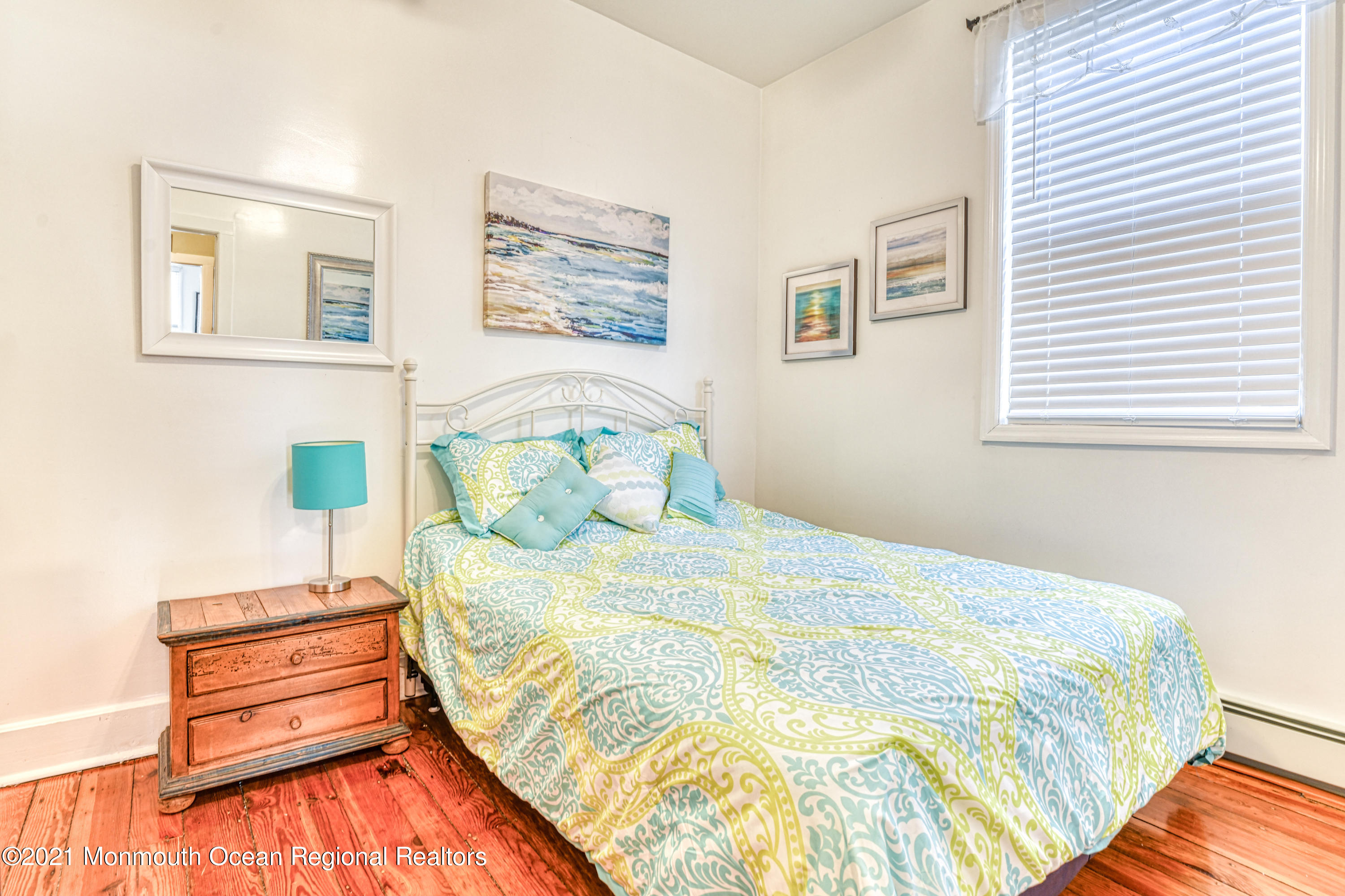 35 Ocean Pathway, Unit 1 Ocean Grove, NJ 07756 - Photo 13 of 14 a bedroom with a bed and wooden floor