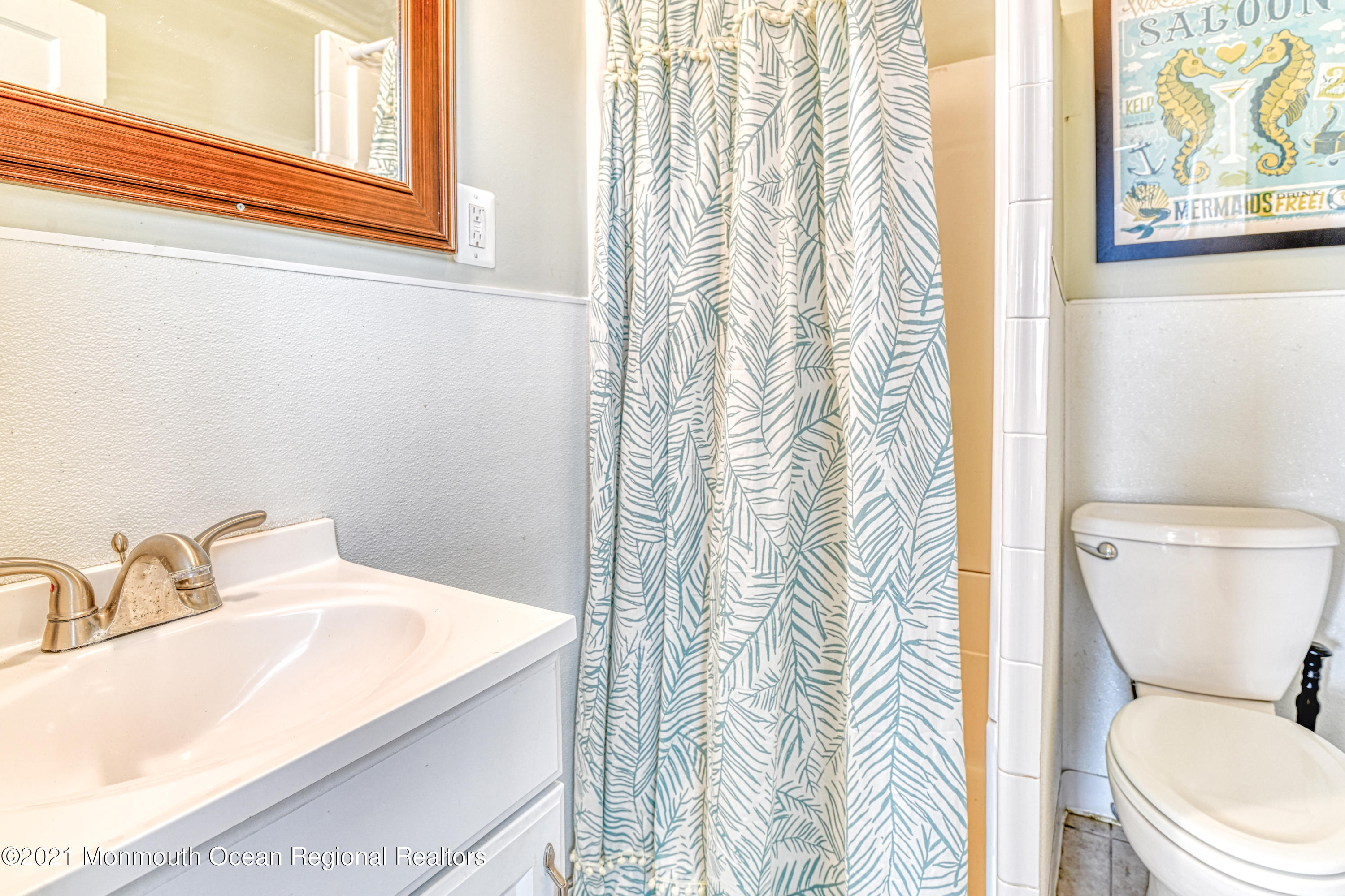 35 Ocean Pathway, Unit 1 Ocean Grove, NJ 07756 - Photo 14 of 14 a white toilet sitting next to a bathroom sink