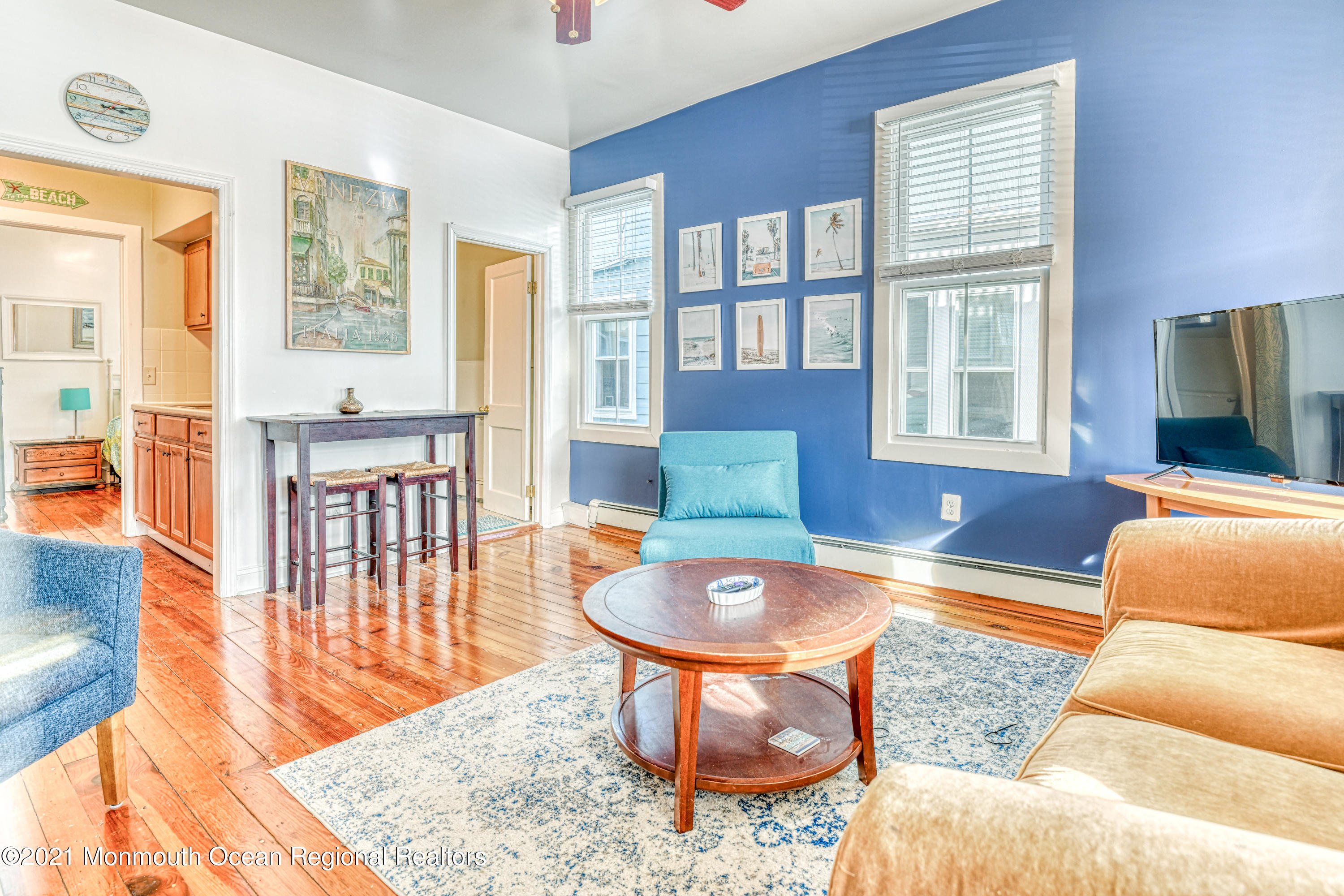 35 Ocean Pathway, Unit 1 Ocean Grove, NJ 07756 - Photo 7 of 14 a living room with furniture a flat screen tv and a large window