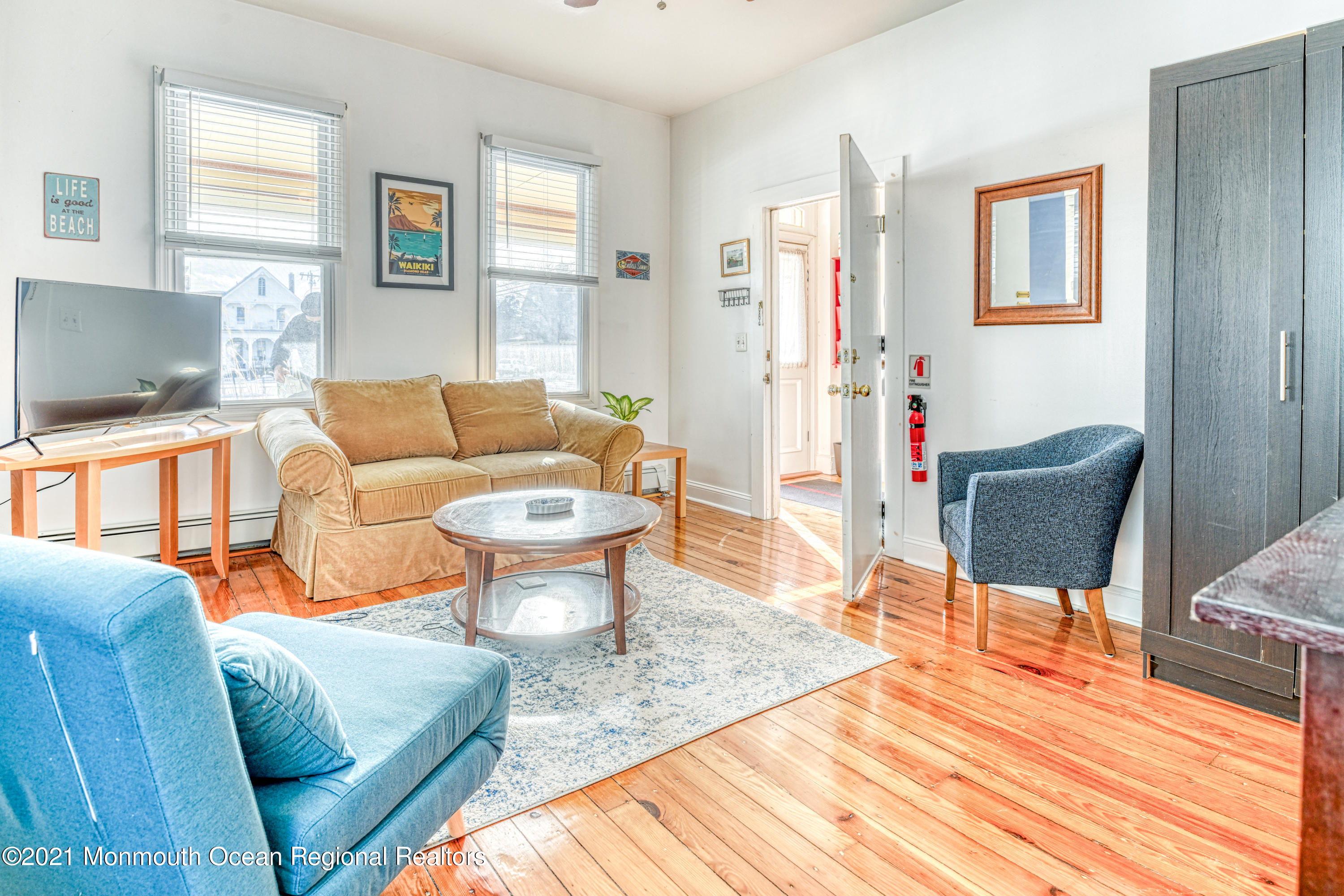 35 Ocean Pathway, Unit 1 Ocean Grove, NJ 07756 - Photo 8 of 14 a living room with furniture a wooden floor and a fireplace