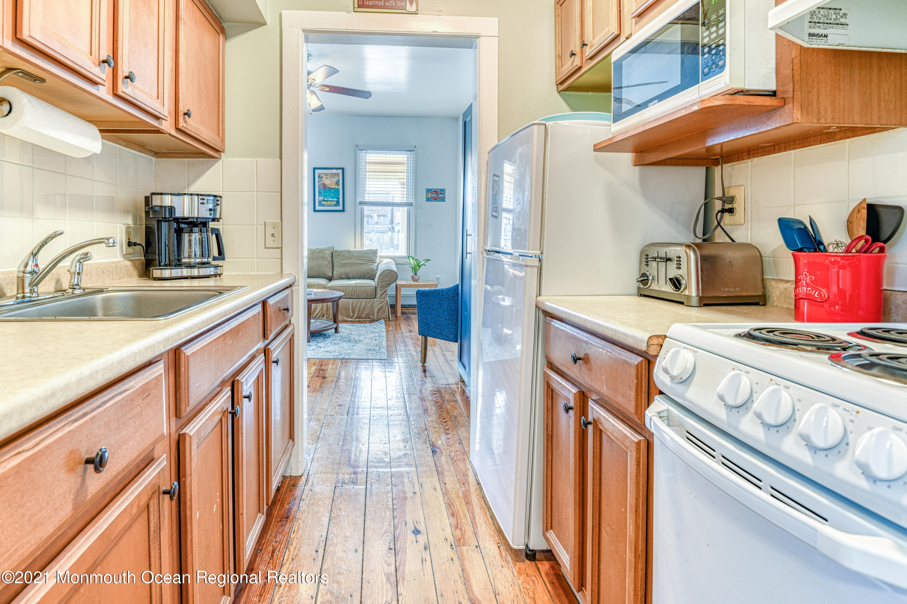 35 Ocean Pathway, Unit 1 Ocean Grove, NJ 07756 - Photo 10 of 14 a kitchen with stainless steel appliances granite countertop a sink and cabinets