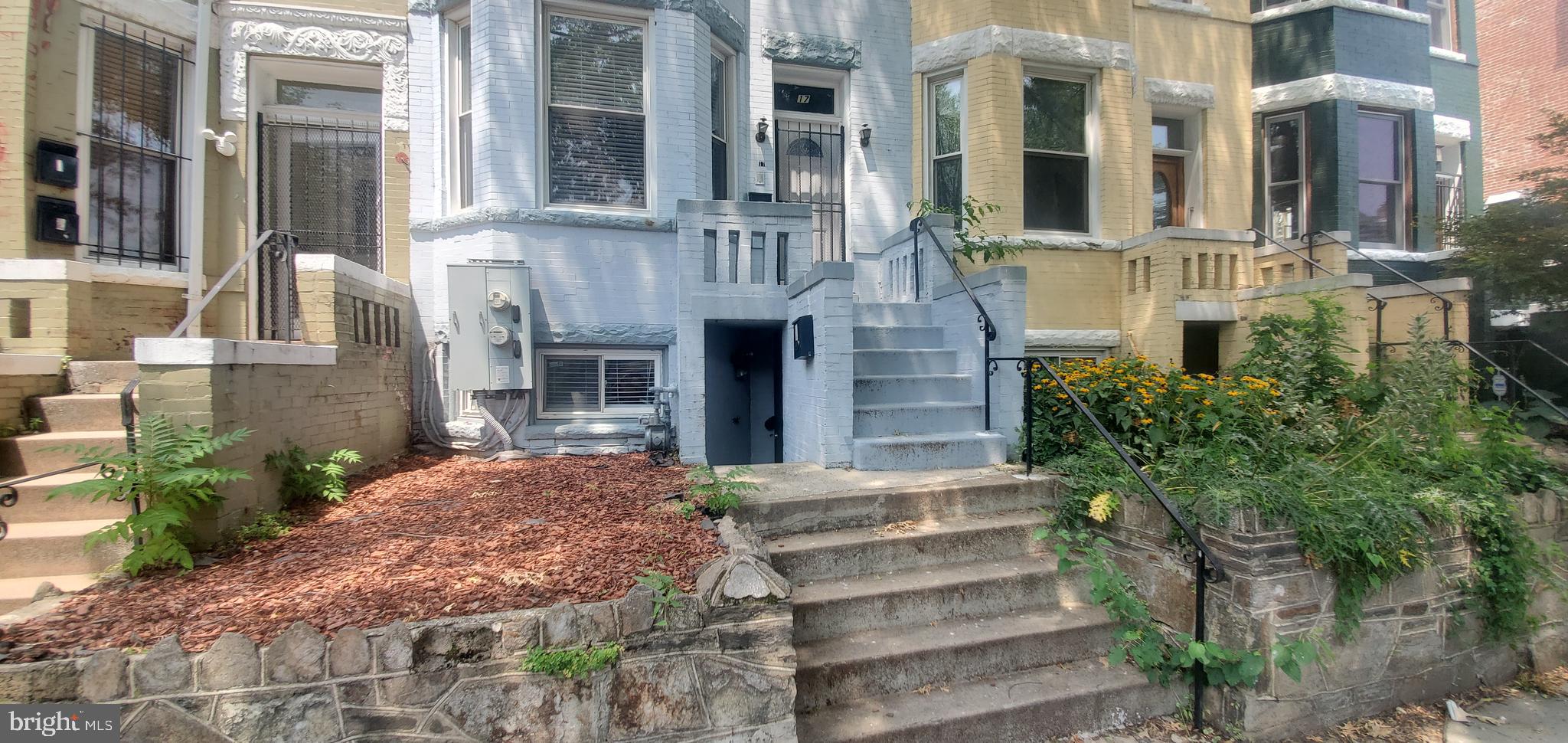 17 Quincy Place Northwest, Unit B Washington, DC 20001 - Photo 20 of 22 a front view of a house with a yard