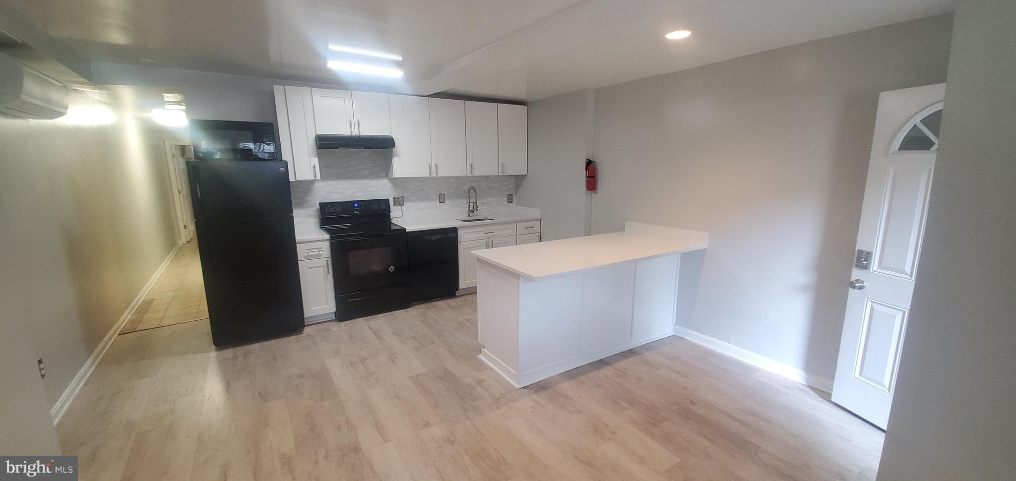 17 Quincy Place Northwest, Unit B Washington, DC 20001 - Photo 3 of 22 a kitchen with stainless steel appliances a refrigerator and a sink