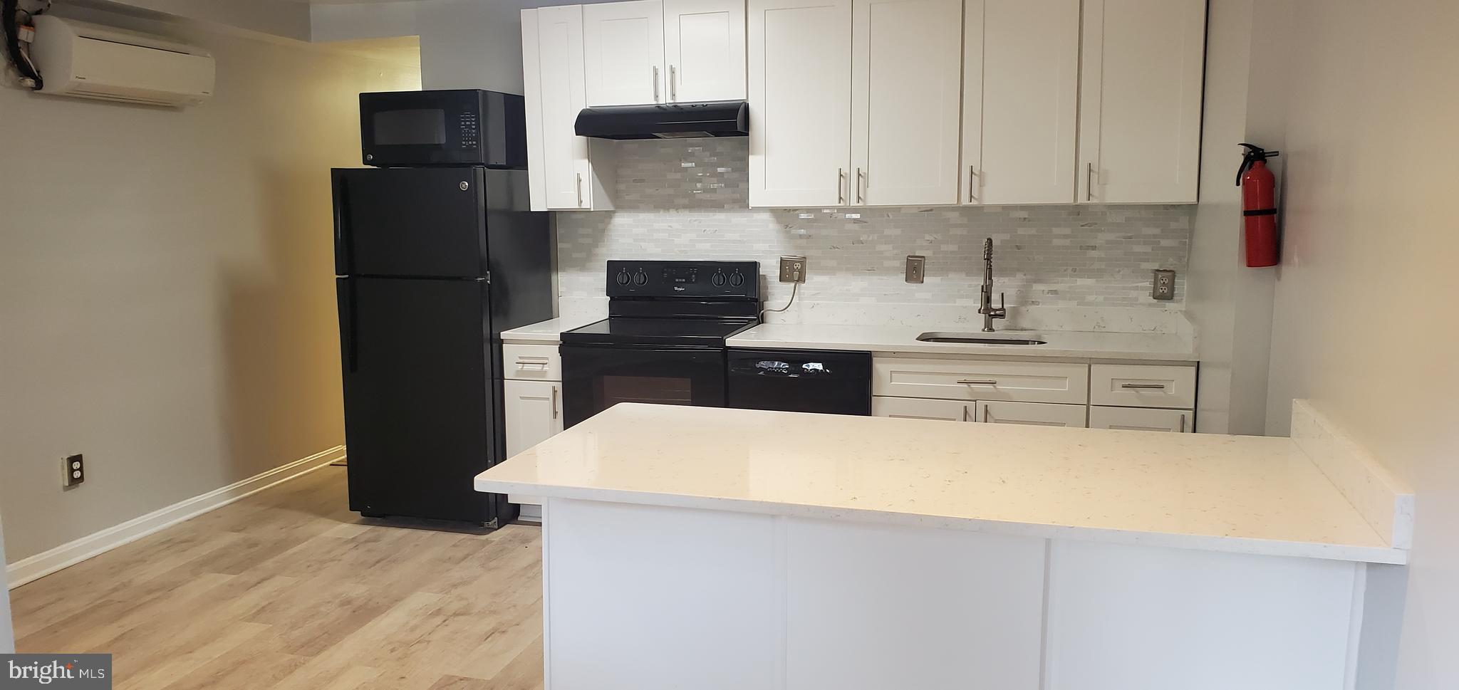 17 Quincy Place Northwest, Unit B Washington, DC 20001 - Photo 5 of 22 a kitchen with stainless steel appliances a refrigerator sink and stove