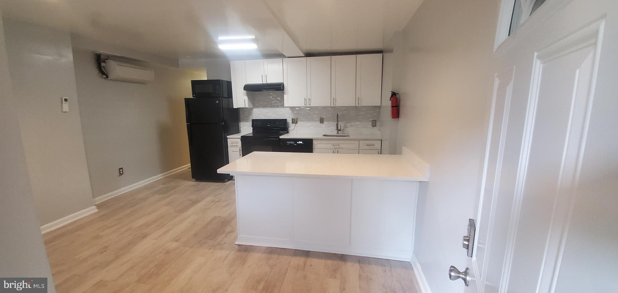 17 Quincy Place Northwest, Unit B Washington, DC 20001 - Photo 7 of 22 a kitchen with a refrigerator sink and cabinets