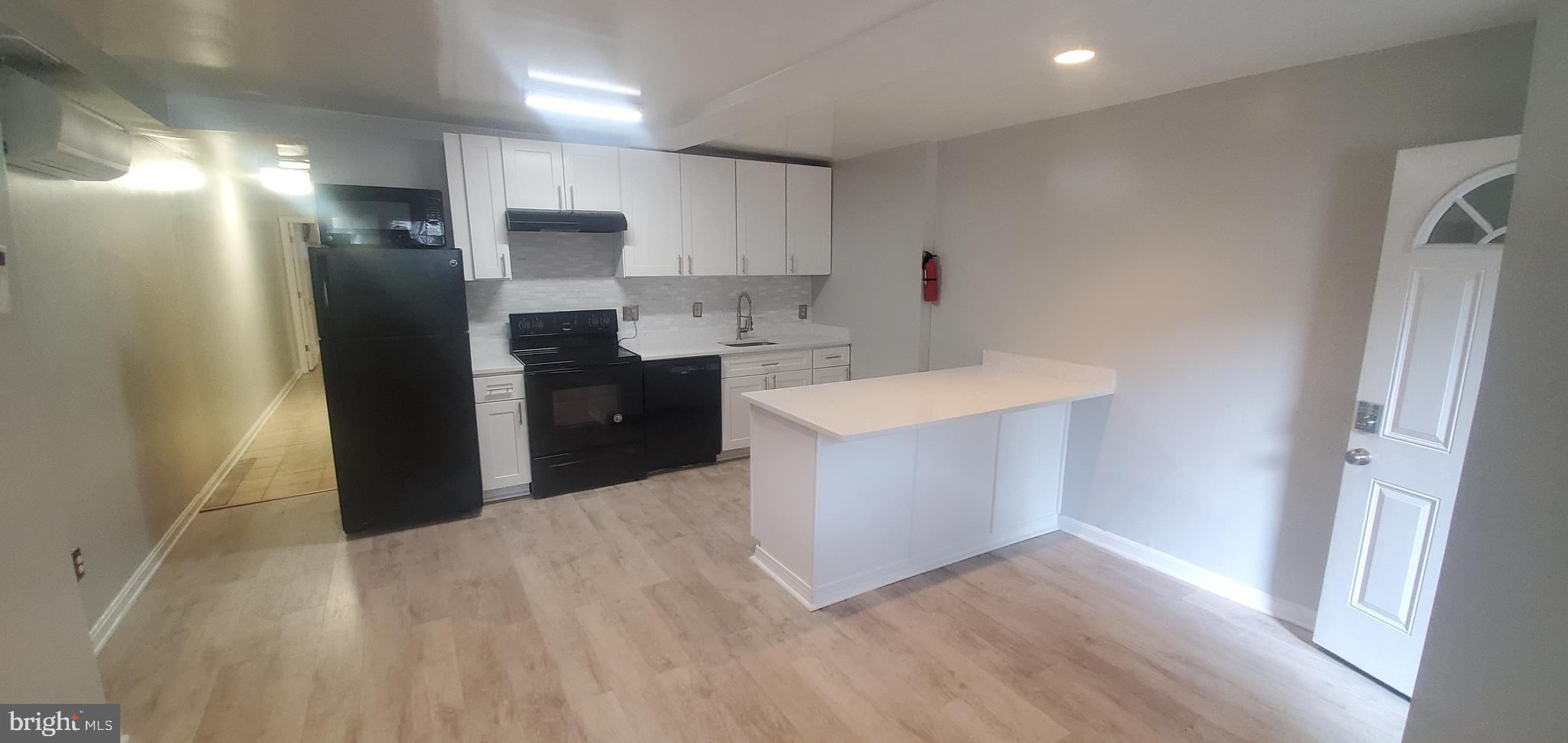 17 Quincy Place Northwest, Unit B Washington, DC 20001 - Photo 8 of 22 a kitchen with a refrigerator and a sink