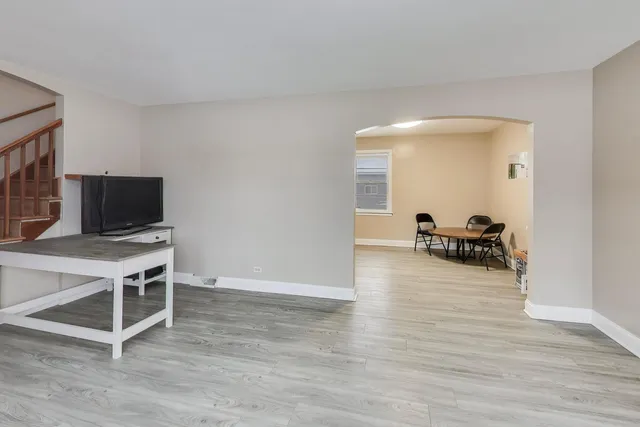 a view of a livingroom with wooden floor and furniture