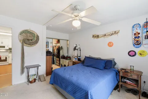 a view of walk in closet with clothes