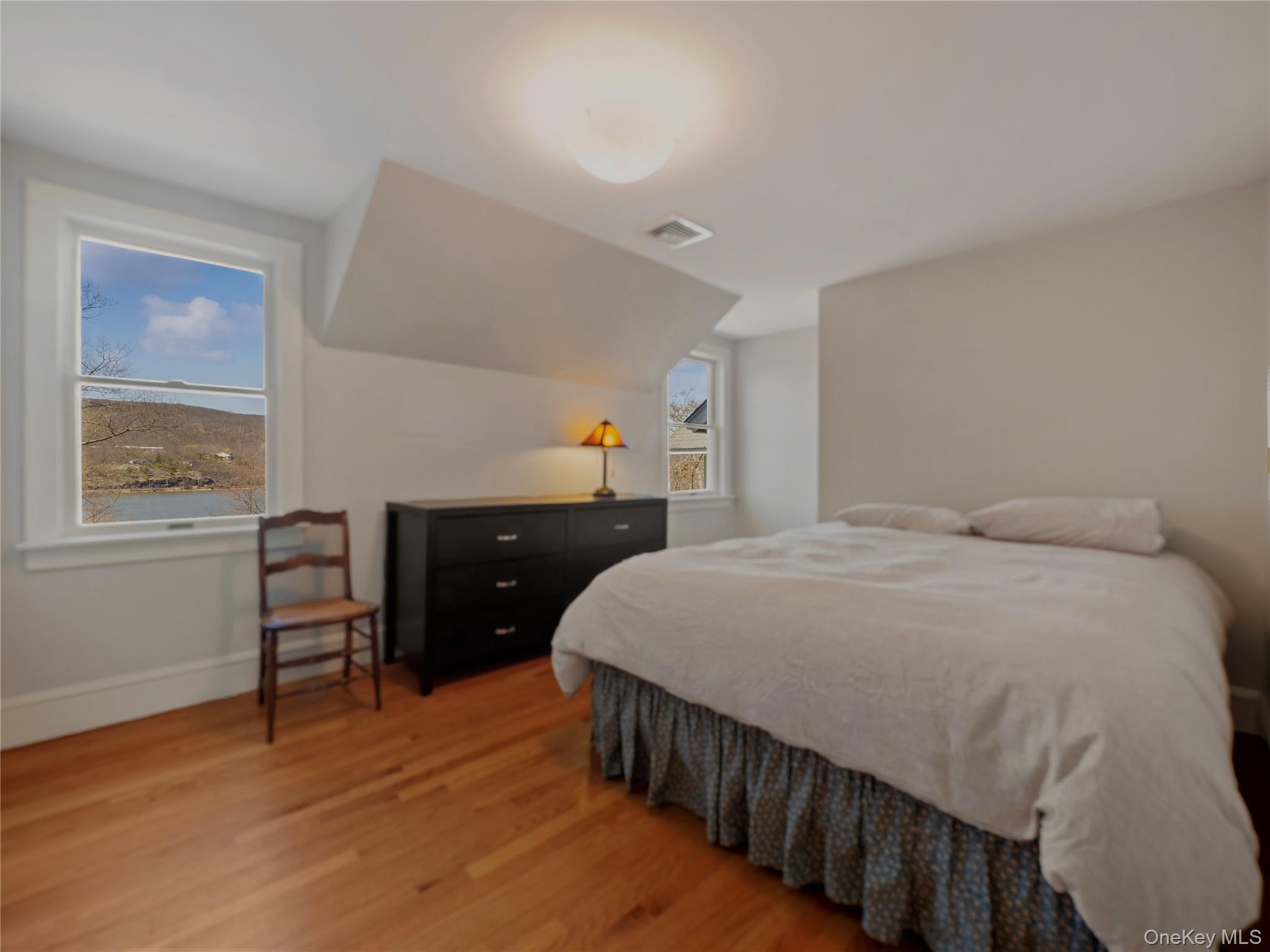 8 Manitou Ridge Garrison, NY 10524 - Photo 20 of 32 a bed room with a bed and a chair