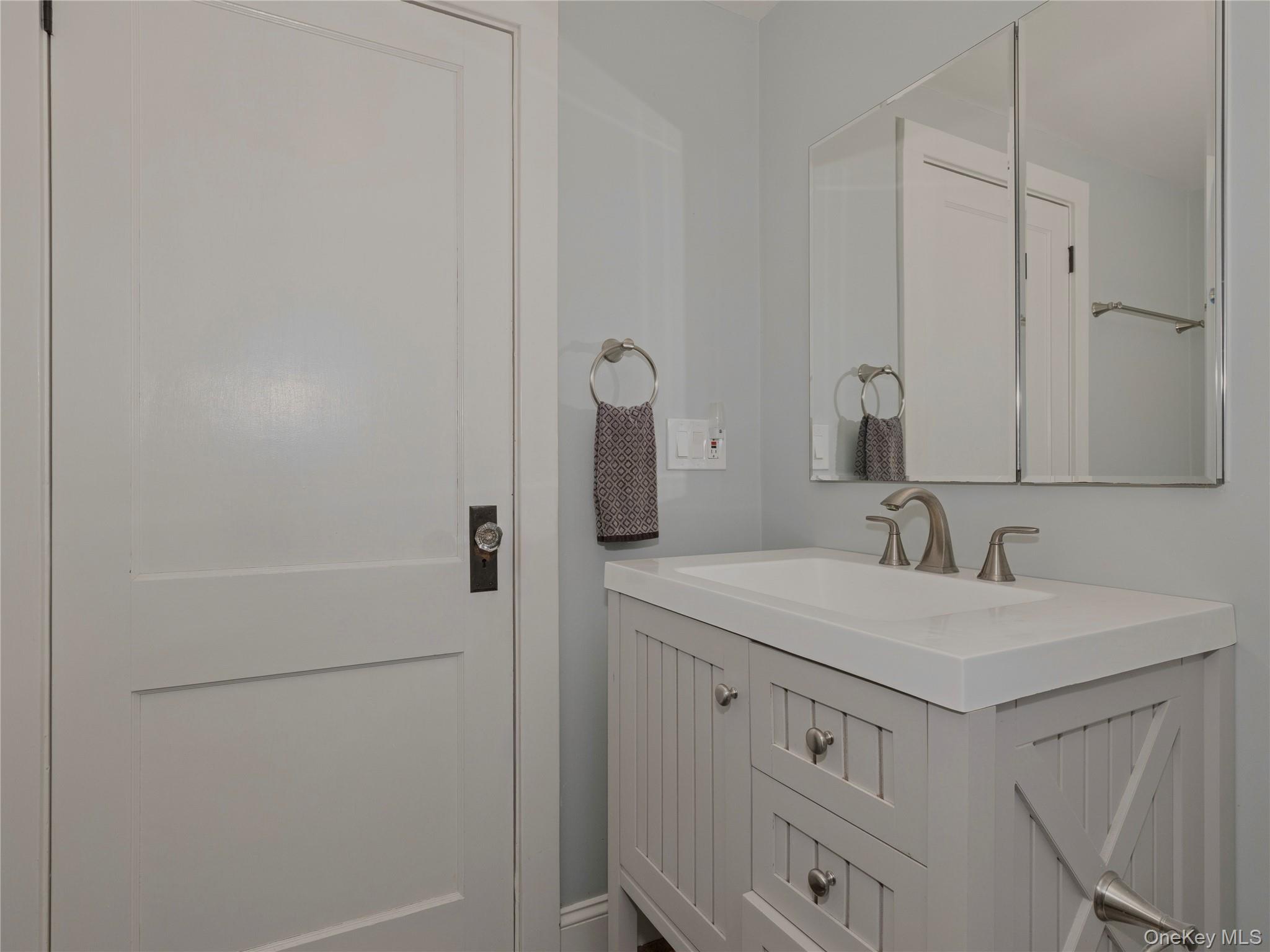 8 Manitou Ridge Garrison, NY 10524 - Photo 23 of 32 a bathroom with a sink and a mirror