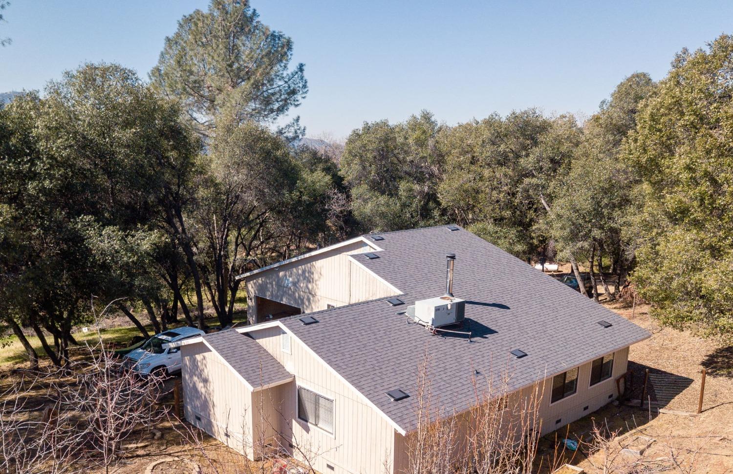 40809 Jean Road West Oakhurst, CA 93644 - Photo 1 of 39 an aerial view of a house with a yard